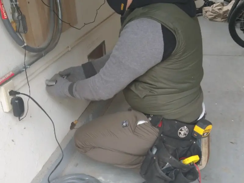 Electrician performing outlet wiring in a East Chicago garage